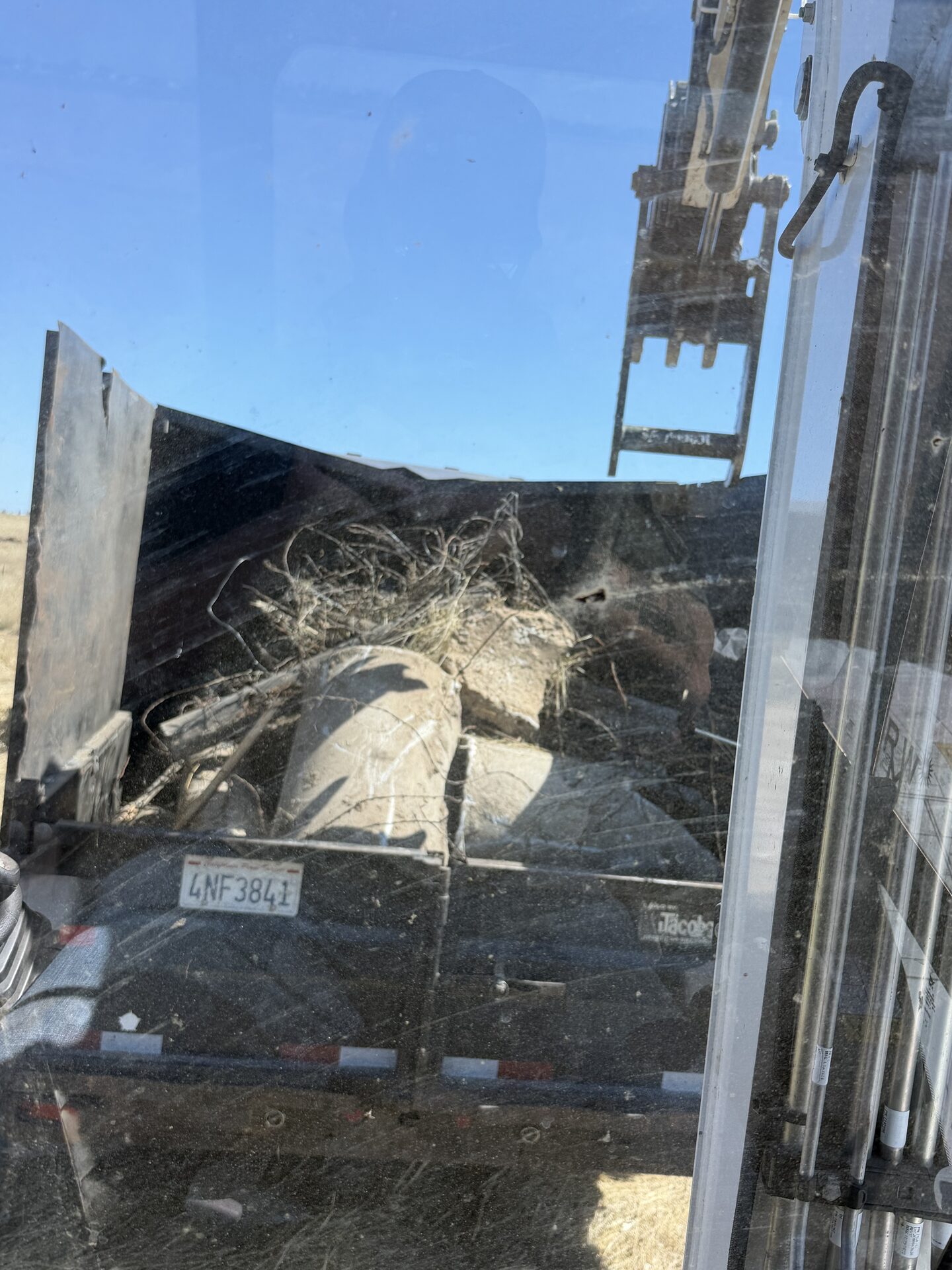 CKJ Ag Services loaded dump trailer hauling debris in Oakdale, California
