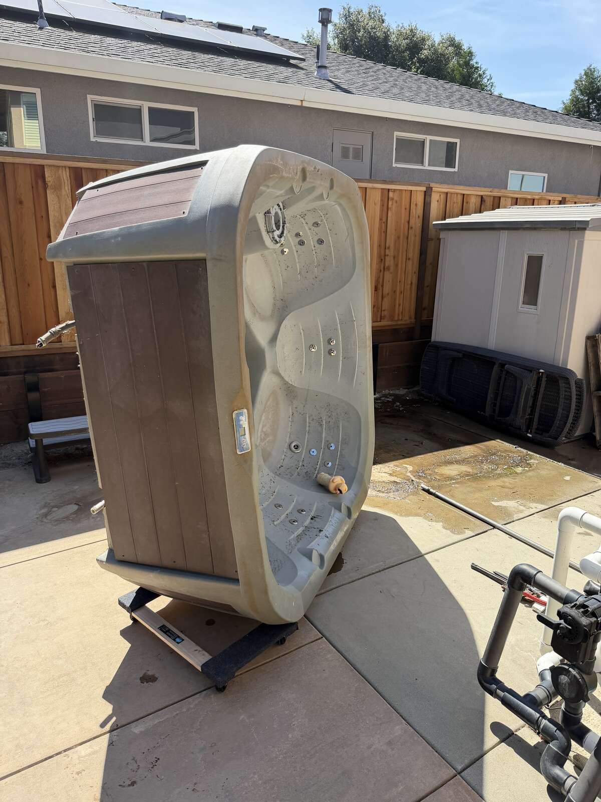 CKJ Ag Services removing an old hot tub from a backyard property